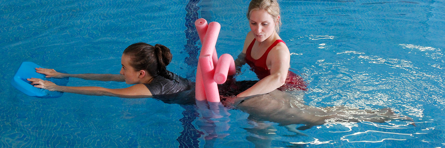 Female uses water aids to help recover in Hydrotherapy session.