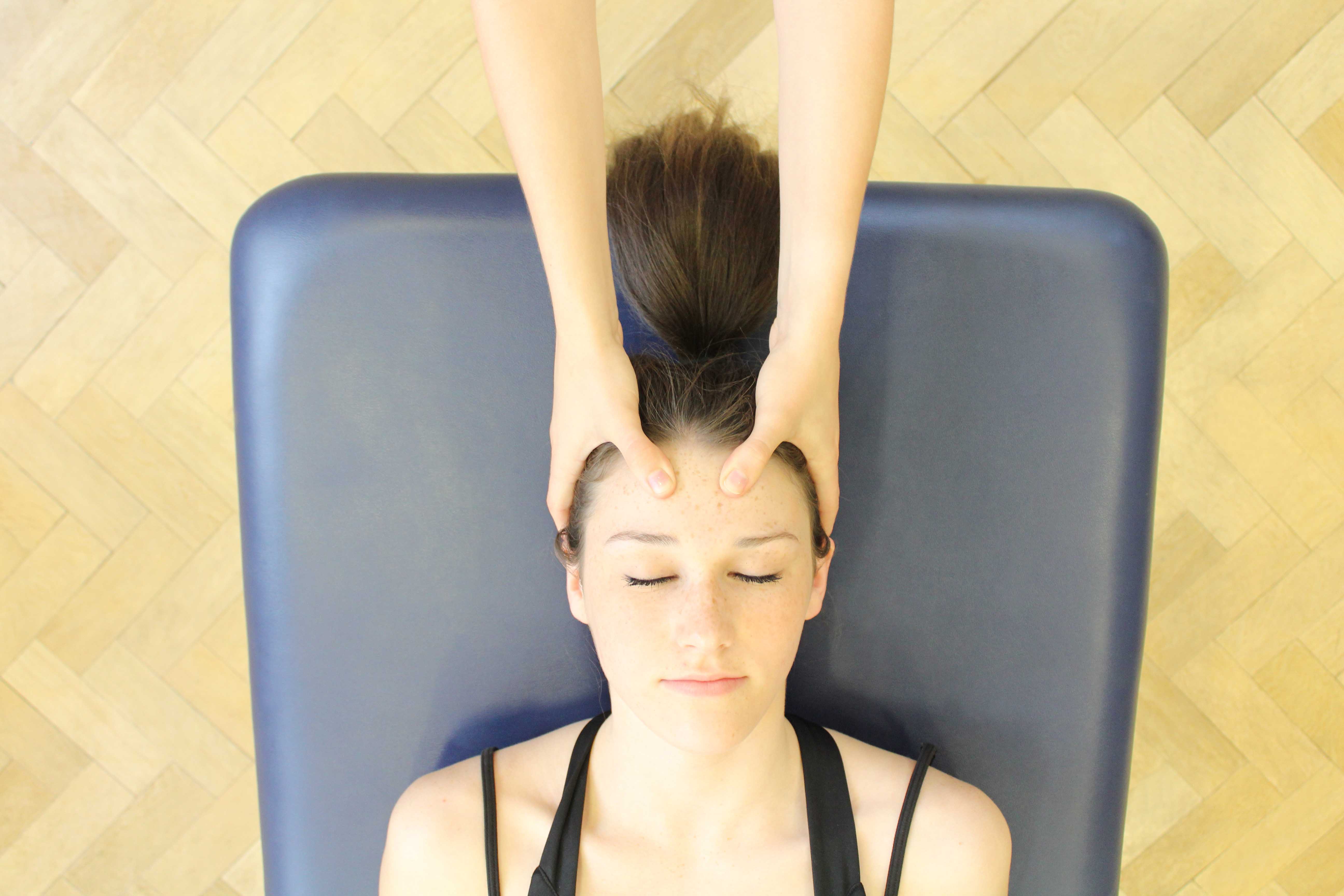 Soft tissue massage of the head, neck and shoulders to relieve tension, pressure and aching